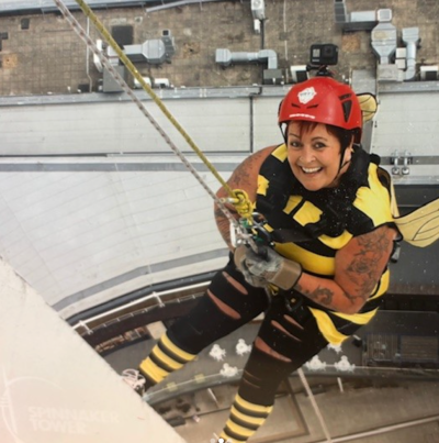 Chrissy in bee costume abseiling Spinnaker Tower