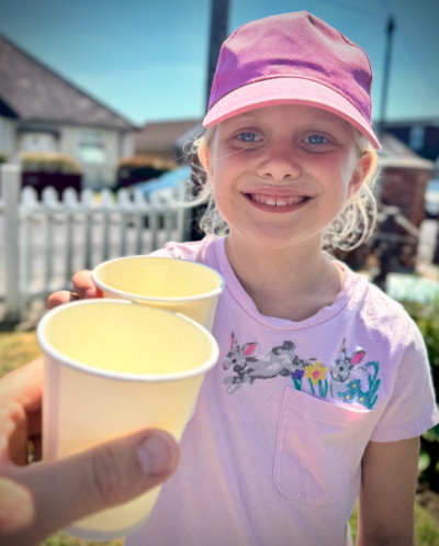 Sylvie drinks lemonade to celebrate her achievement