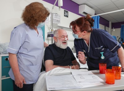 2 nurses with patient in bed.jpg