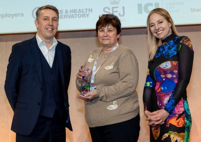 A photo showing Tina Jackson accepting her award