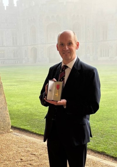 Picture showing Peter with his OBE outside Windsor Castle