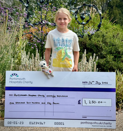 Sylvie holding a giant cheque