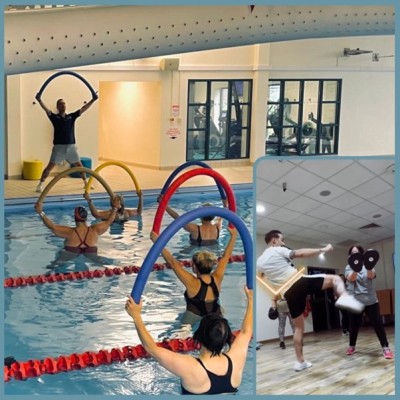 People in swimming pool with floats during swimming fitness class